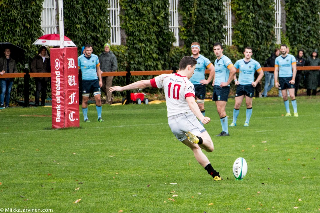 Irish rugby: UCD Rugby (blue shirt) and Trinity Rugby (white shirt) playing in rainy Dublin, Ireland 2016.