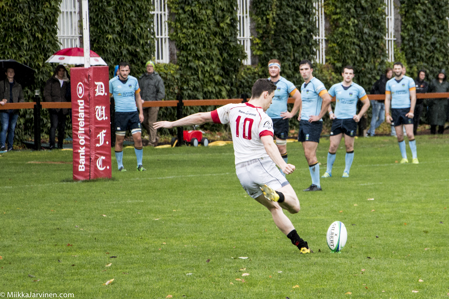 Irish rugby: UCD Rugby (blue shirt) and Trinity Rugby (white shirt) playing in rainy Dublin, Ireland 2016.